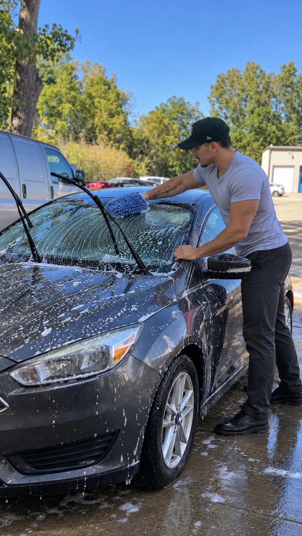 A person cleaning a vehicle before it is rented.